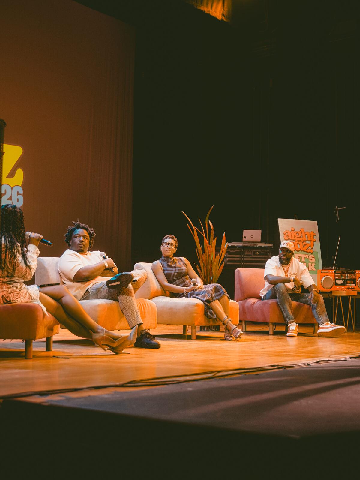 The Defying The Diploma panel seated on stage at CousinzCon