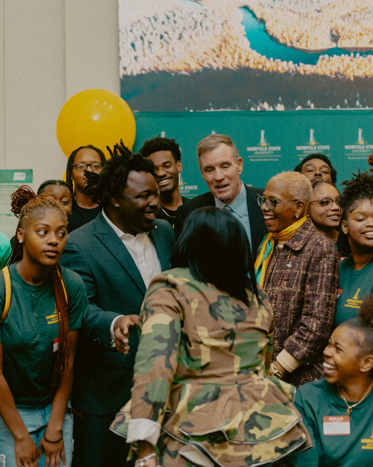 Reggie Prevail and U.S. Senator Mark Warner surrounded by Norfolk State University students after their fireside chat